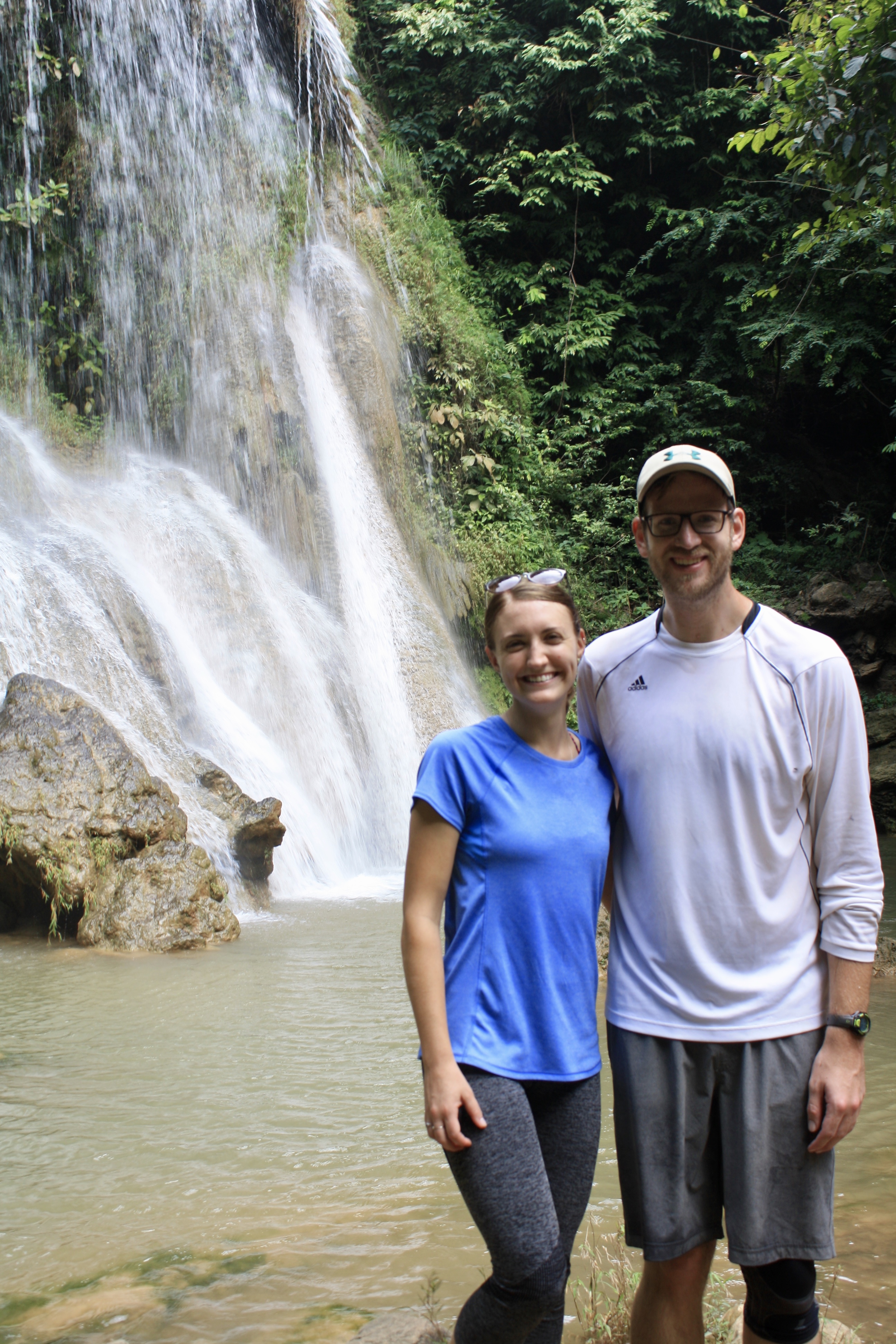 Two individuals at waterfall 
